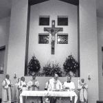 The newly created crucifix, made from pews of the old church, is a focal point in the sanctuary during the dedication Mass of St. Mary, Hamburg celebrated by Bishop Cullen, Dec 8, 2000.