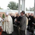 The Most Rev. Edward P. Cullen, D.D., Bishop of Allentown, leads the ribbon-cutting Sept. 22, 2003 at the dedication ceremony of “Expansion 2003 … Because We Care,” a $1.2 million expansion that will enhance the quality of life for the 208 residents of Holy Family Manor, Bethlehem. Joining him are, from left, Judee M. Bavaria, N.H.A., R.H.P.F., President of the HFM Board of Directors; and Jim Polaski, N.H.A., Administrator of HFM.