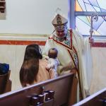 Bishop Schlert greets a women and her baby at the 2024 Women's Advent Retreat